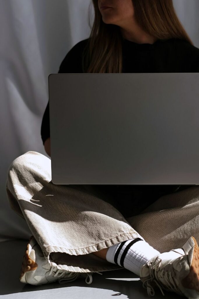 woman on laptop using canva, showing an example of 3 canva font pairings, free canva template download