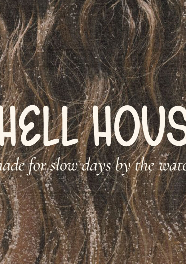 Shell House beachwear logo created with Gelato Daydreams hand-drawn display font over a sandy ocean photograph for relaxed coastal branding and apparel design.